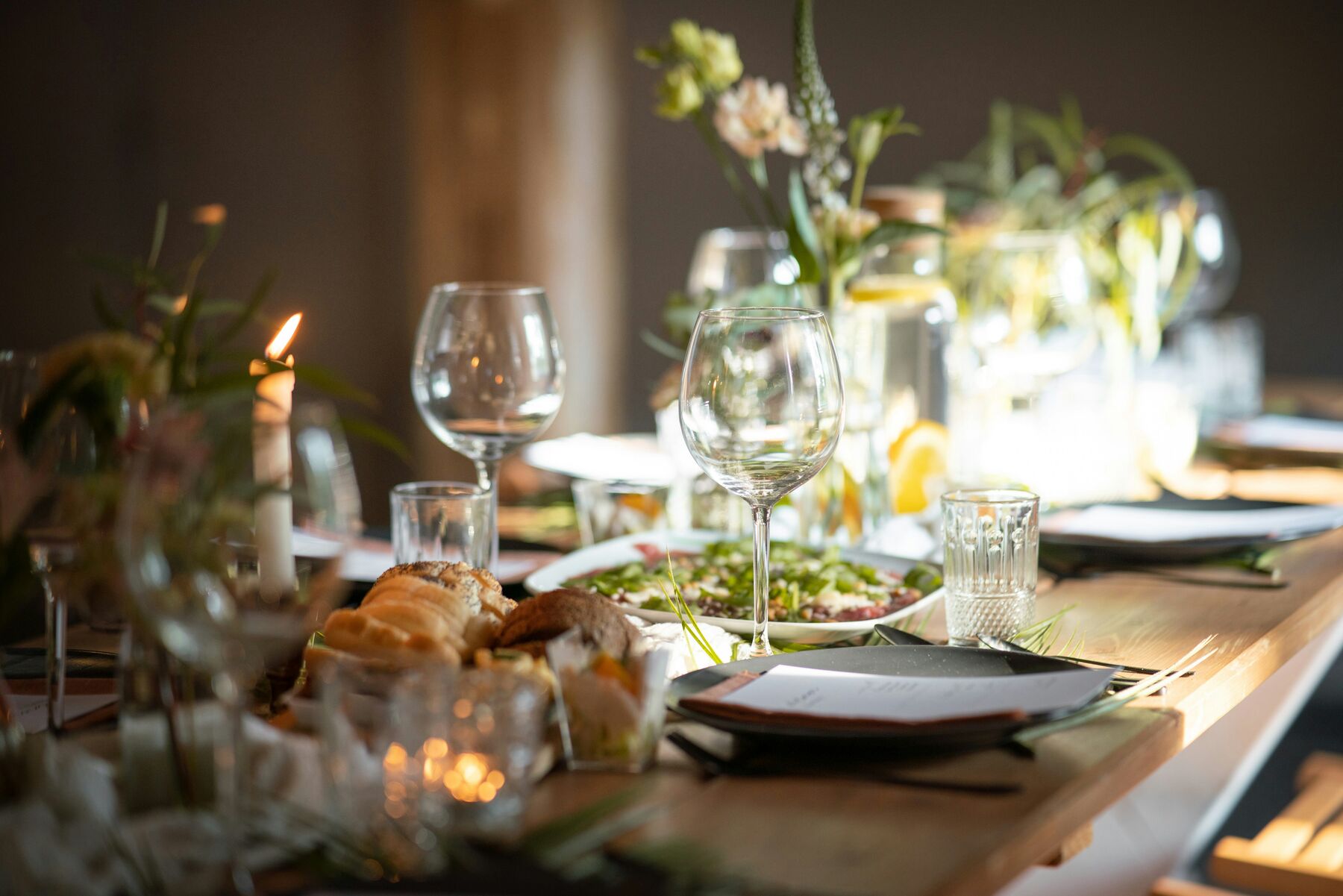 Candlelit table laid for a private birthday or anniversary dinner